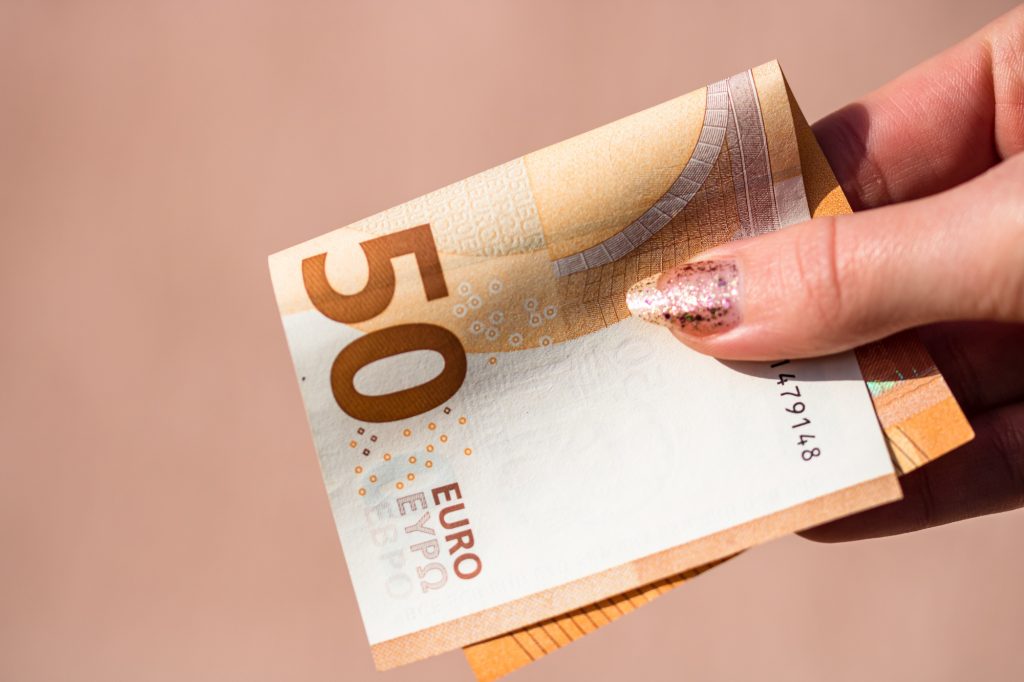 Closeup shot of a person holding a 50 euro bill