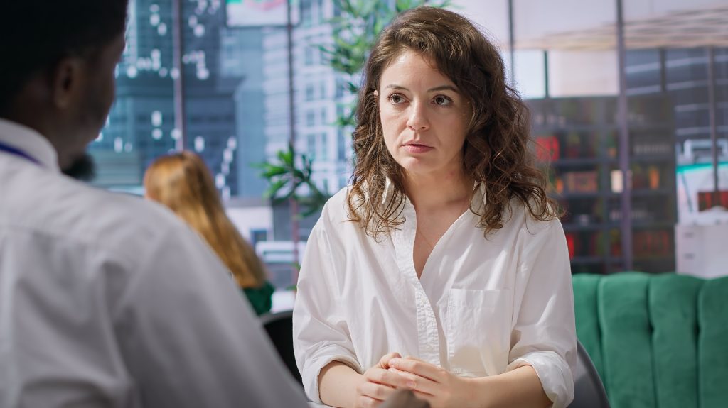 HR manager rejecting an unqualified young woman for a certain job opening